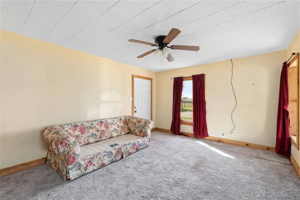 a spacious bedroom with a bed and a window
