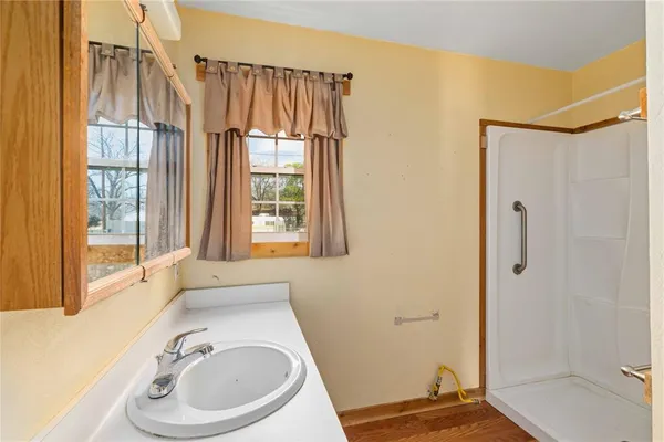 a bathroom with a sink a toilet a tub and shower