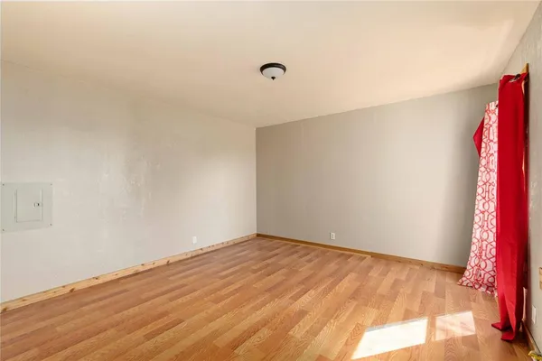 a view of a room with wooden floor and white walls