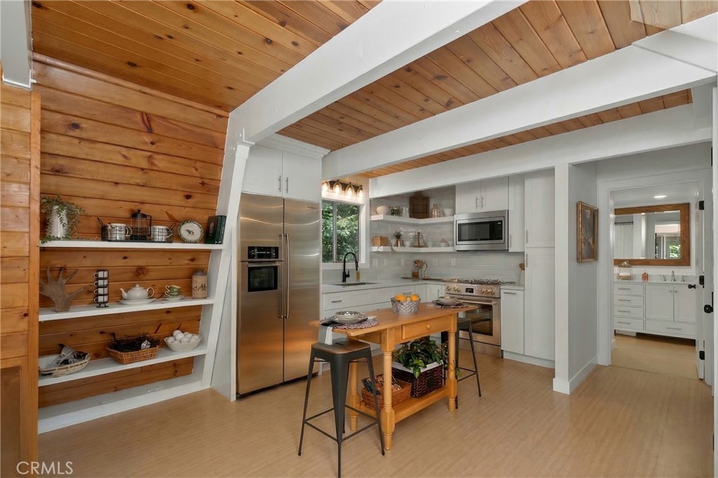 26980 Everest Road Lake Arrowhead, CA 92391 - Photo 11 of 49 a dining room with furniture and a kitchen