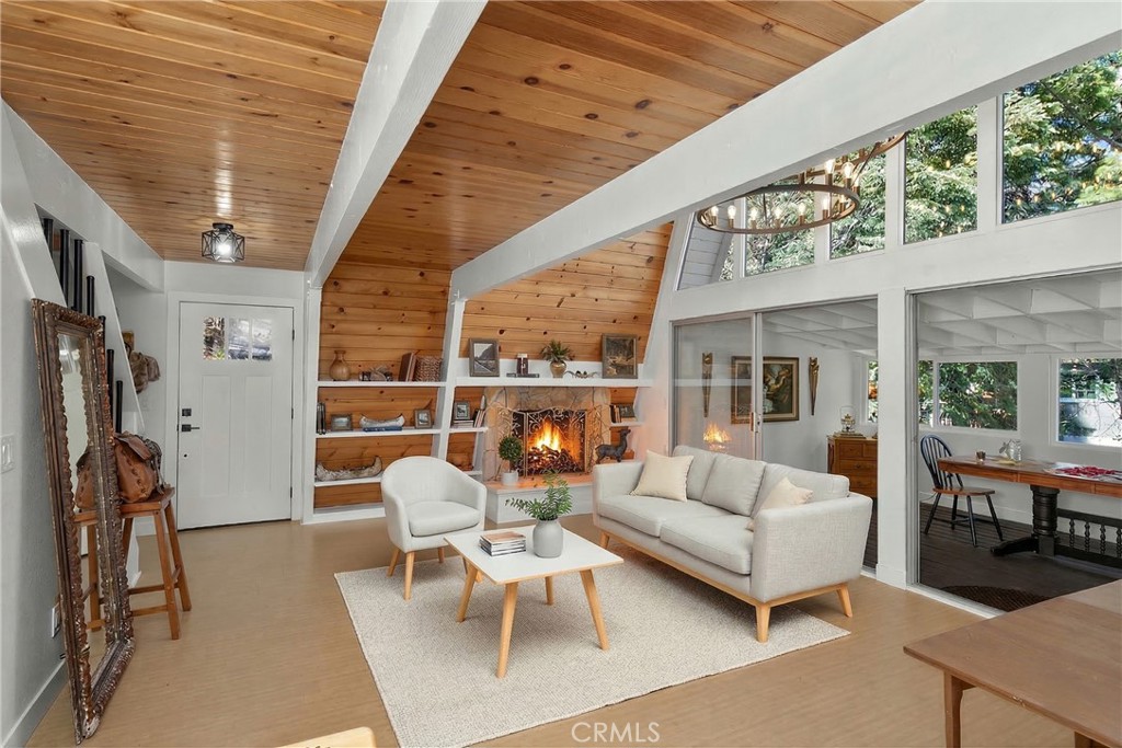 26980 Everest Road Lake Arrowhead, CA 92391 - Photo 2 of 49 a living room with furniture and a floor to ceiling window