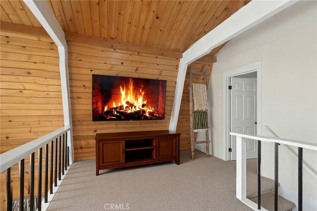 26980 Everest Road Lake Arrowhead, CA 92391 - Photo 24 of 49 a living room with furniture a fireplace and a flat screen tv