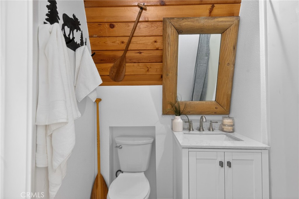26980 Everest Road Lake Arrowhead, CA 92391 - Photo 32 of 49 a bathroom with a toilet sink and mirror