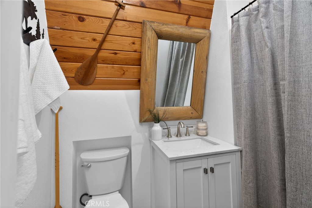 26980 Everest Road Lake Arrowhead, CA 92391 - Photo 33 of 49 a bathroom with a sink a toilet and shower