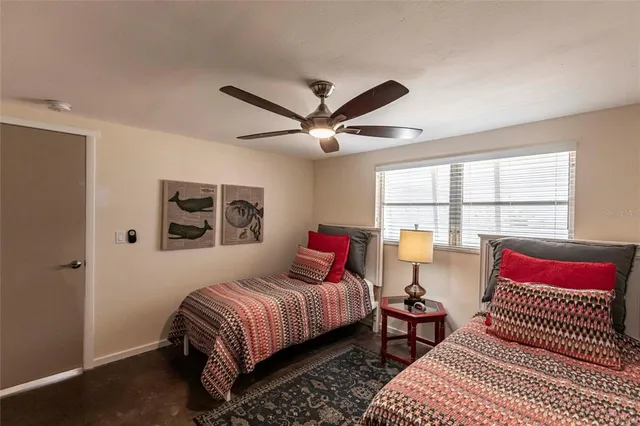 a bedroom with a large bed and a window