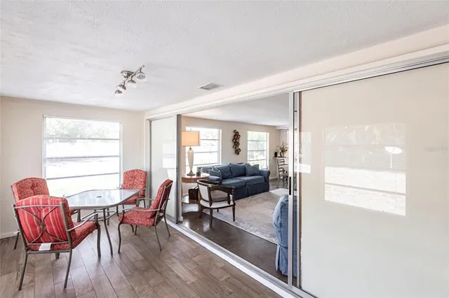 a view of a dining room with furniture and wooden floor