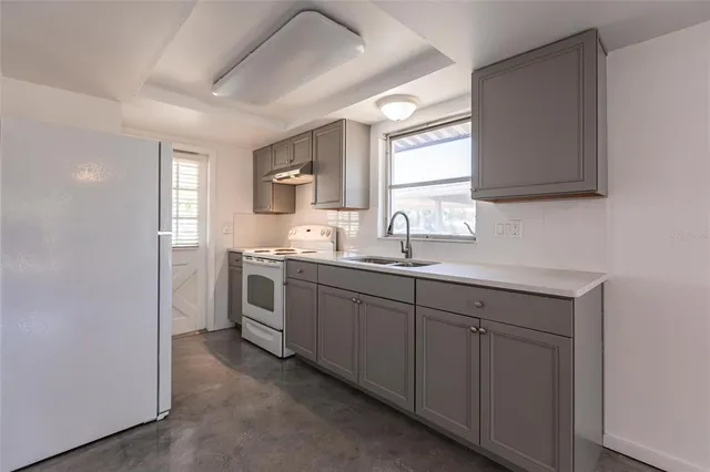 a kitchen with sink cabinets and window