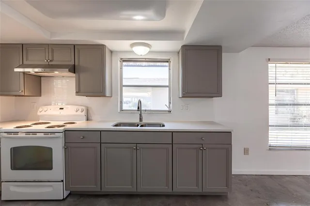 a kitchen with a sink cabinets and window
