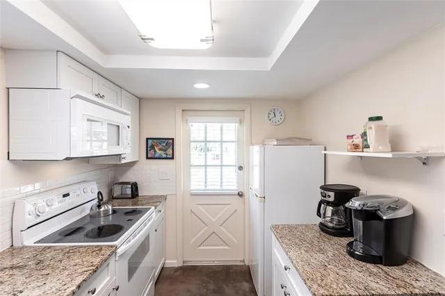 a kitchen with a stove and a refrigerator