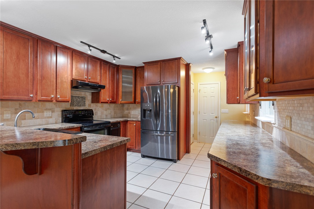 202 Keowee Trail Seneca, SC 29672 - Photo 9 of 35 This functional kitchen features ample cabinetry and a tiled backsplash, offering a practical space for daily living.