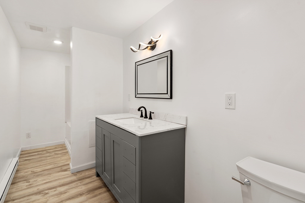 87 Vincent Street Springfield, MA 01129 - Photo 12 of 32 a bathroom with a sink a toilet and mirror