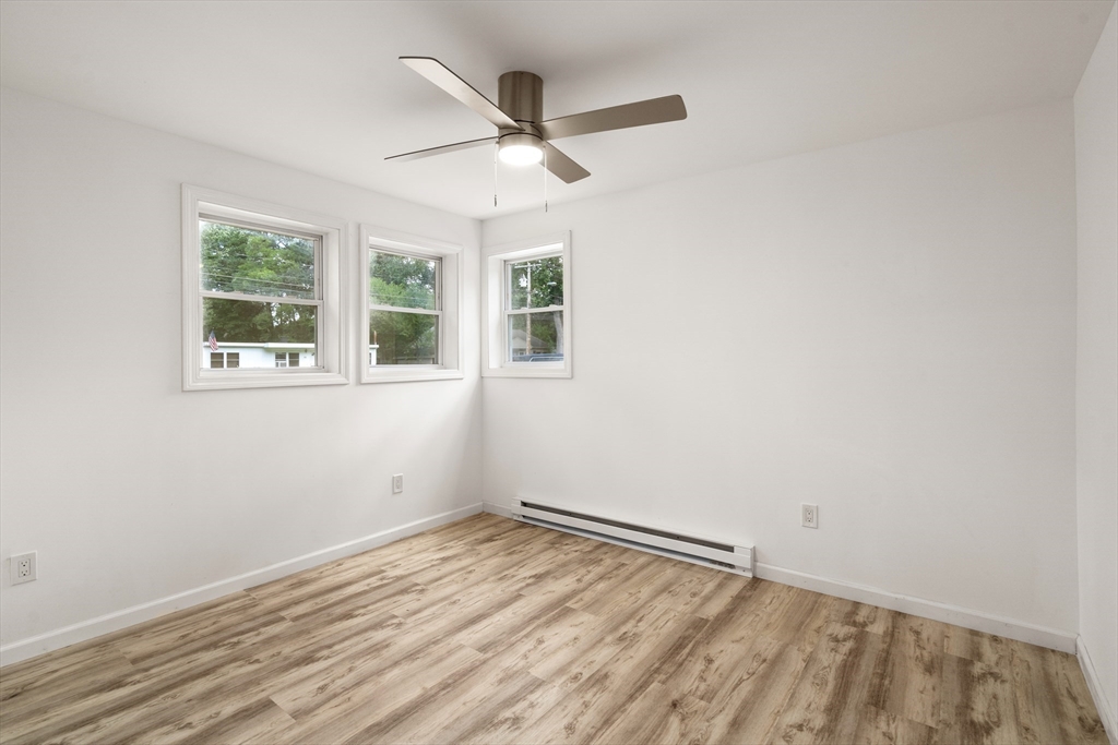 87 Vincent Street Springfield, MA 01129 - Photo 16 of 32 an empty room with a window and ceiling fan
