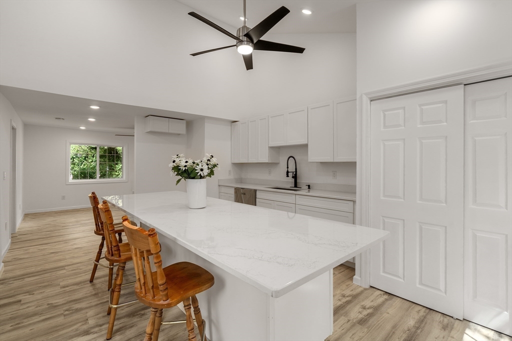 87 Vincent Street Springfield, MA 01129 - Photo 8 of 32 a kitchen with stainless steel appliances a table chairs and a refrigerator
