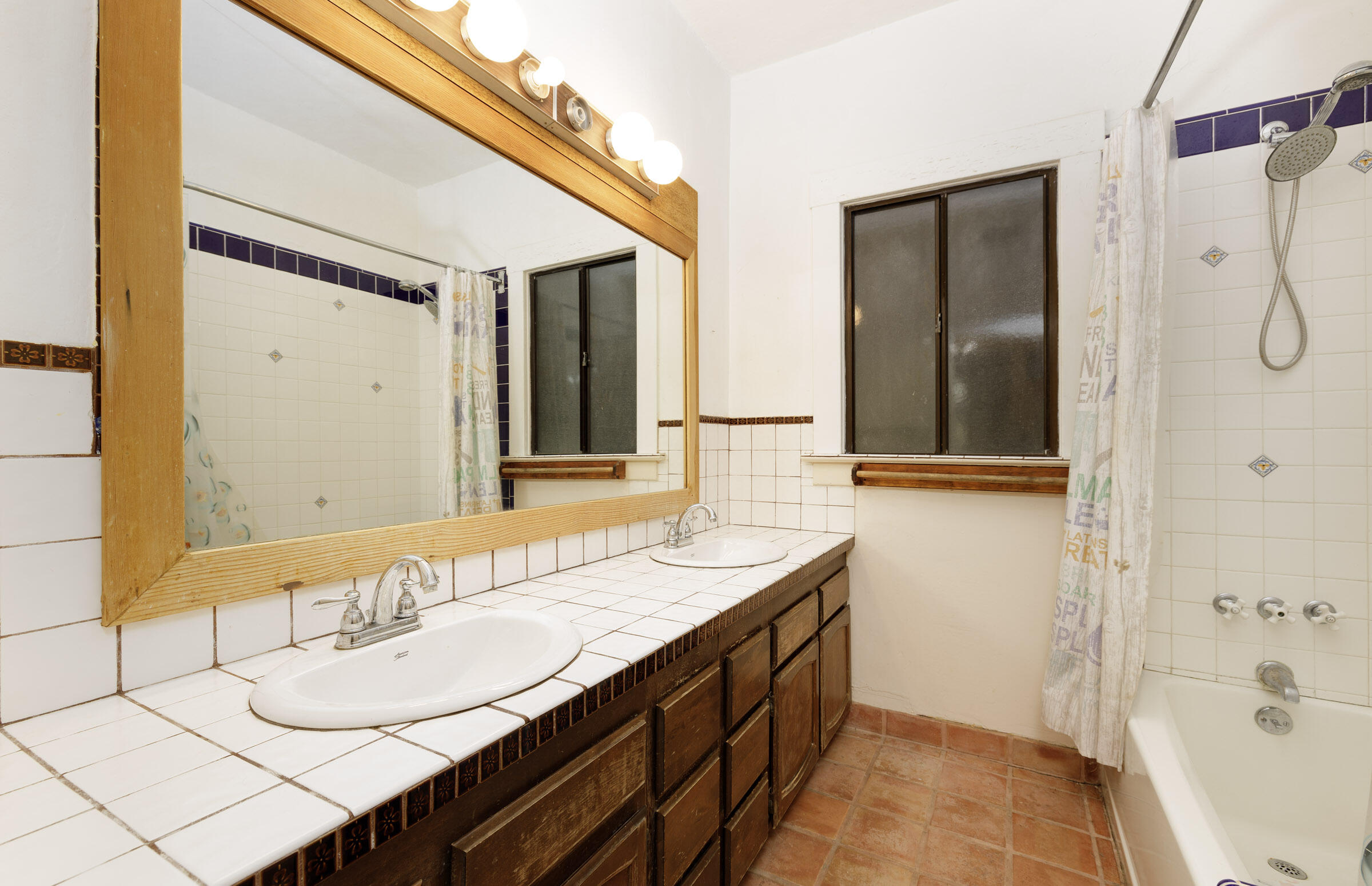 1126 Las Olas Avenue Santa Barbara, CA 93109 - Photo 18 of 24 a bathroom with a granite countertop sink and a mirror