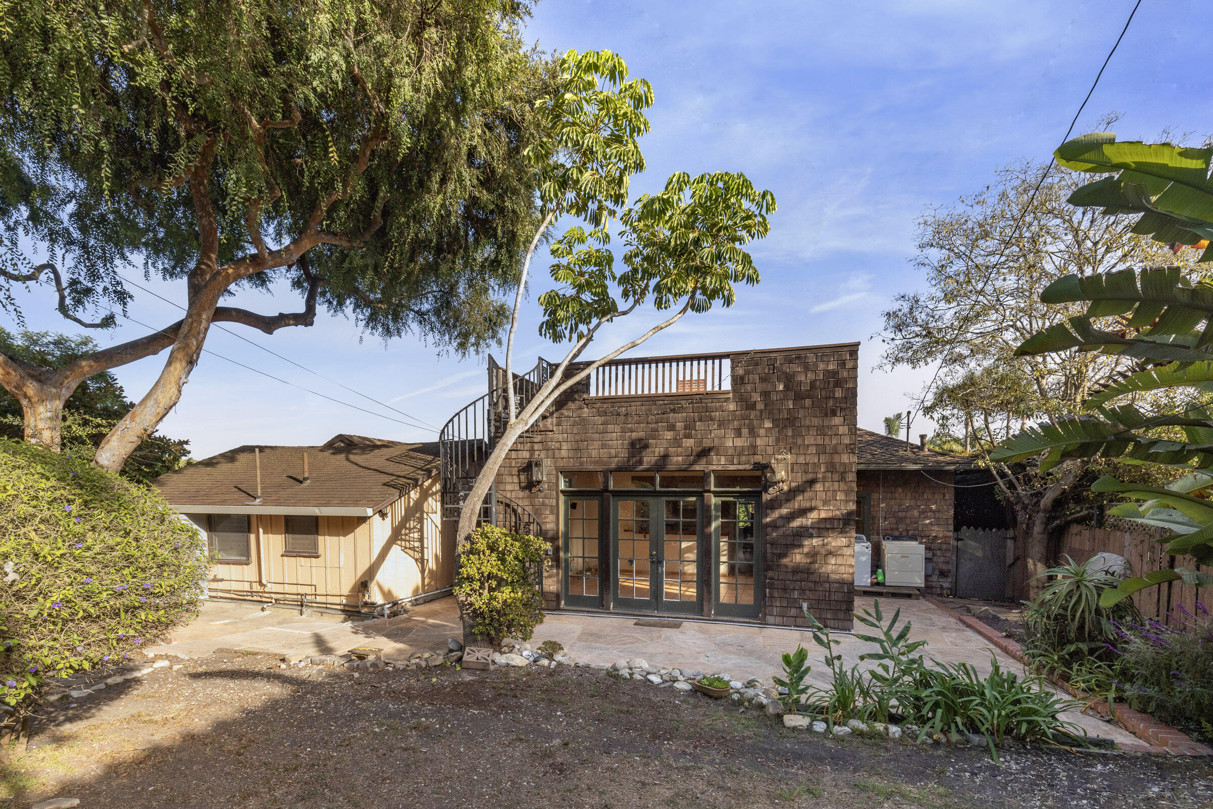 1126 Las Olas Avenue Santa Barbara, CA 93109 - Photo 7 of 24 a view of a house with a tree and a yard