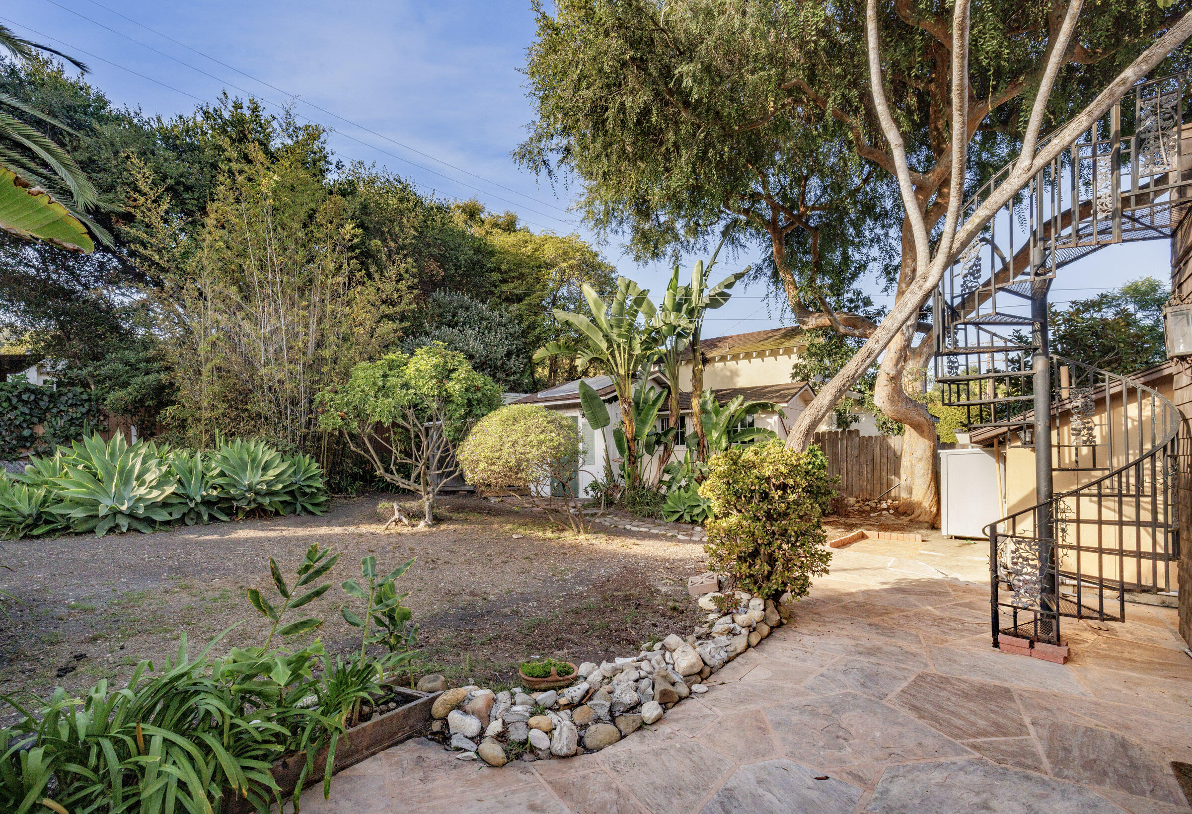 1126 Las Olas Avenue Santa Barbara, CA 93109 - Photo 8 of 24 a view of a yard with plants and trees