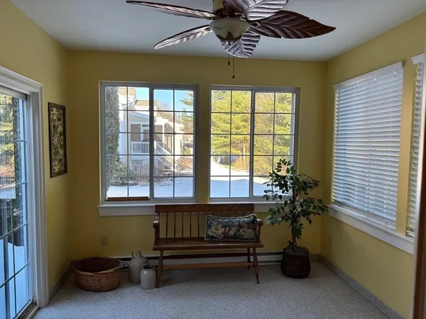 a bedroom with furniture and a large window