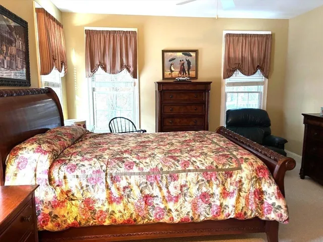 a bedroom with a bed and a painting on the wall