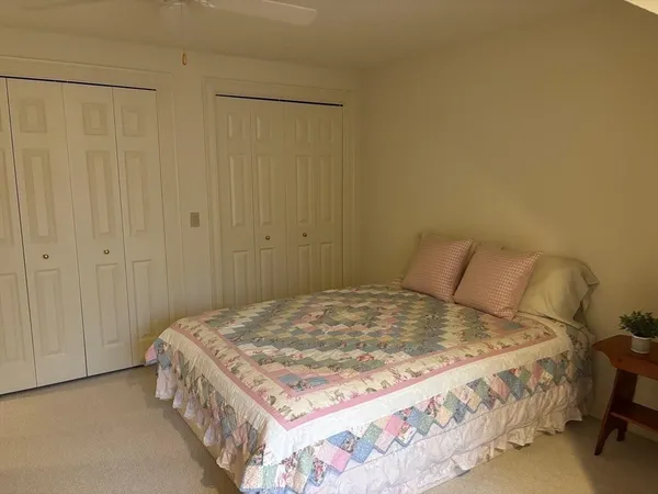 a bedroom with a bed and a cabinet