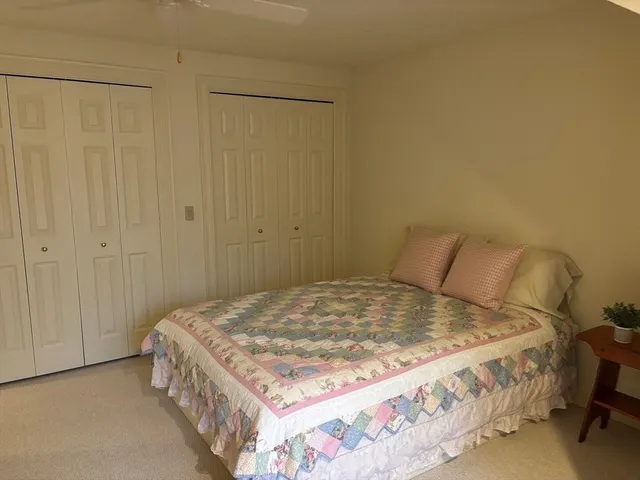 a bedroom with a bed and a cabinet