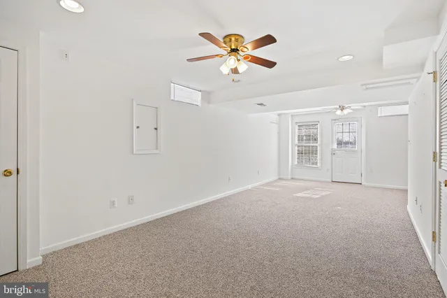 a view of an empty room with a ceiling fan