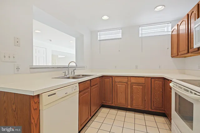 a kitchen with a sink cabinets and appliances