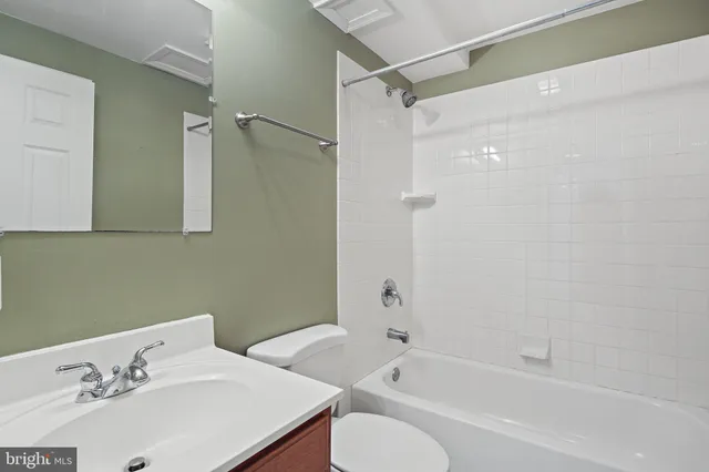 a bathroom with a sink mirror toilet and bathtub