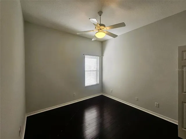 a view of a small space with wooden floor and a window