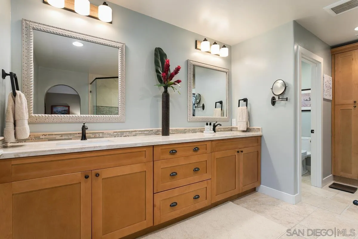 3526 Avenida Sierra Escondido, CA 92029 - Photo 19 of 36 a bathroom with a double vanity sink and a mirror