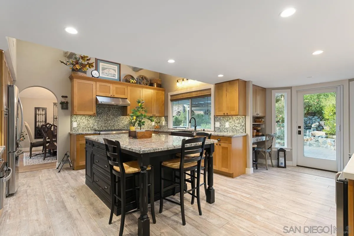 3526 Avenida Sierra Escondido, CA 92029 - Photo 7 of 36 a large kitchen with a table and chairs in it