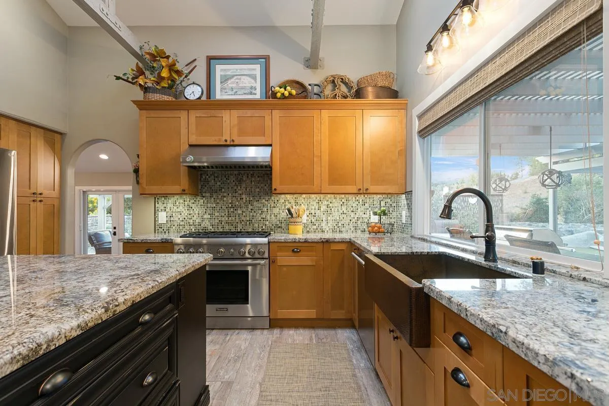 3526 Avenida Sierra Escondido, CA 92029 - Photo 8 of 36 a kitchen with stainless steel appliances granite countertop a sink stove and cabinets