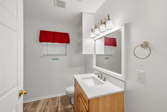 a bathroom with a sink vanity and mirror