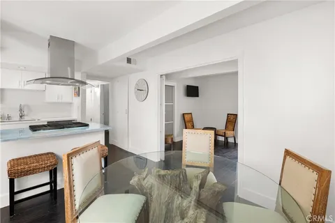 a living room with furniture and a dining table