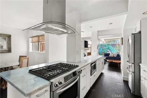 a kitchen with stainless steel appliances granite countertop a stove and a refrigerator