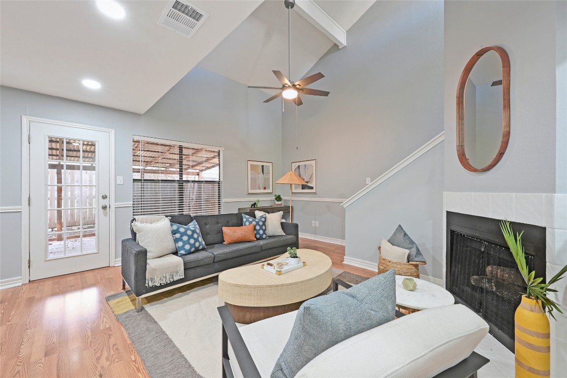 512 Eberhart Lane, Unit 303 Austin, TX 78745 - Photo 1 of 12 a living room with furniture a fireplace and wooden floor