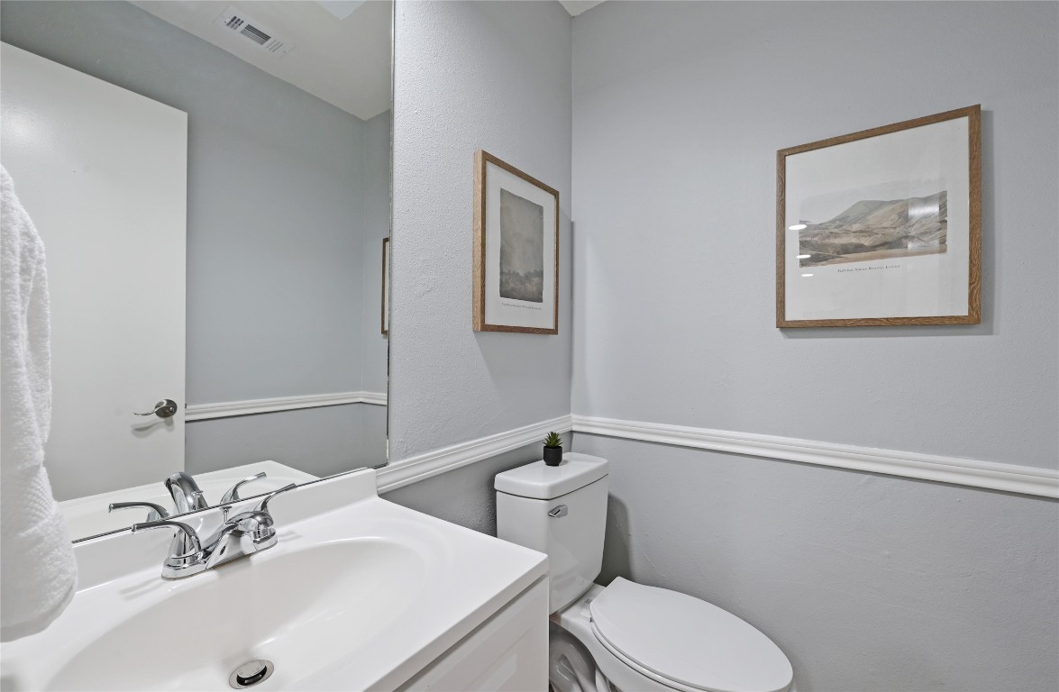 512 Eberhart Lane, Unit 303 Austin, TX 78745 - Photo 12 of 12 a bathroom with a sink mirror and toilet
