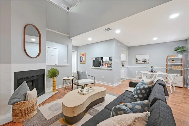 a living room with furniture a fireplace and a wall painting