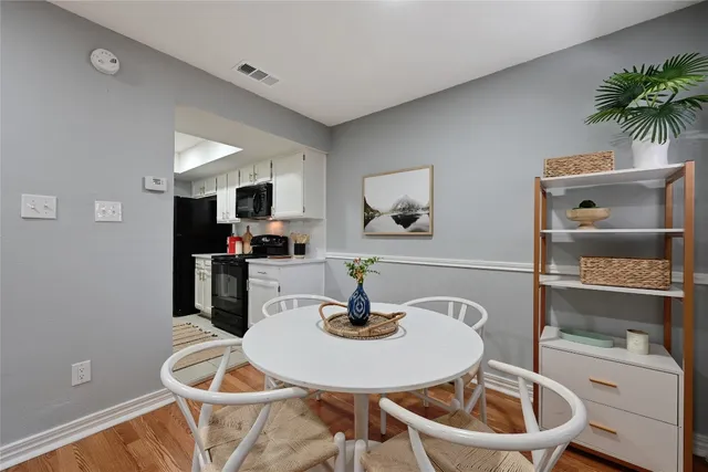 a dining room with a table and chairs