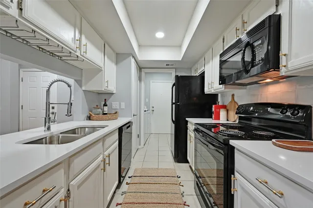 a kitchen that has a sink and a stove