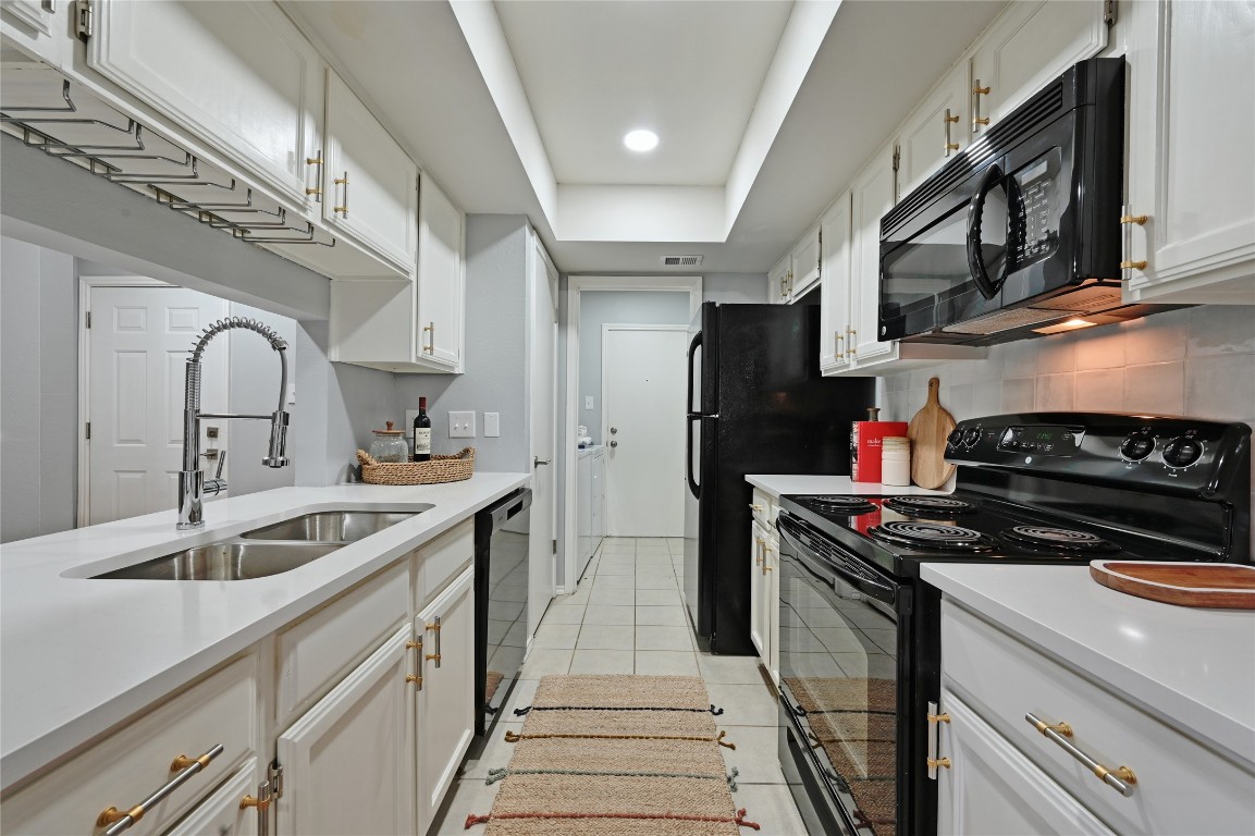 512 Eberhart Lane, Unit 303 Austin, TX 78745 - Photo 7 of 12 a kitchen that has a sink and a stove