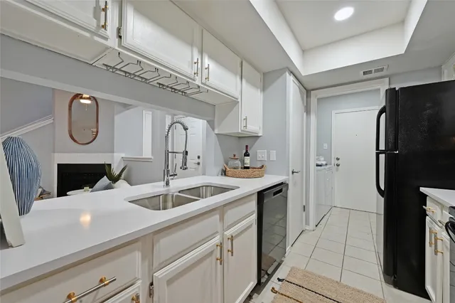 a kitchen with a sink and refrigerator
