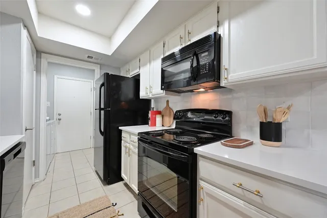 a kitchen with stainless steel appliances granite countertop a refrigerator stove and microwave