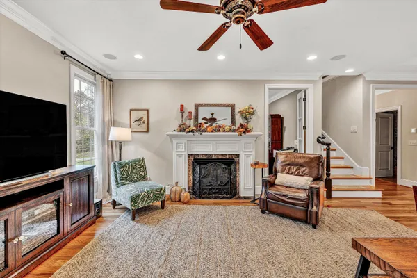 a kitchen with stainless steel appliances kitchen island granite countertop wooden floors and wooden cabinets