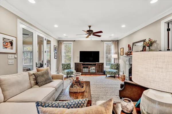 a kitchen with stainless steel appliances granite countertop a stove top oven a sink dishwasher and wooden cabinets with wooden floor