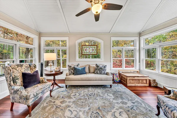 a kitchen with stainless steel appliances granite countertop a sink dishwasher stove and wooden cabinets with wooden floor