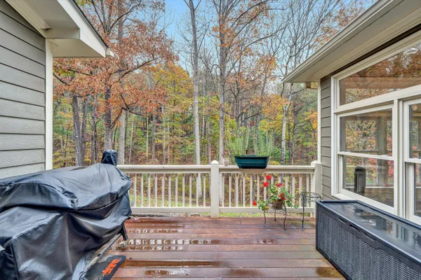 a large bedroom with a bed and wooden floor