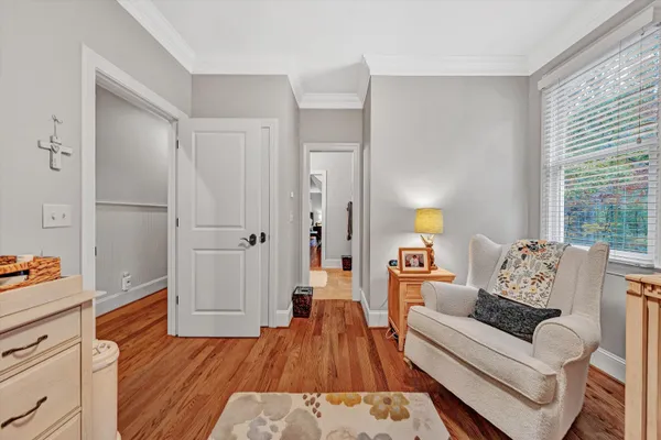a bedroom with furniture and a flat screen tv