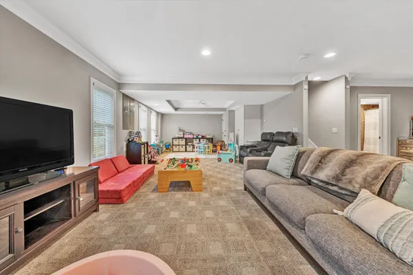a view of a house with a big yard and large trees