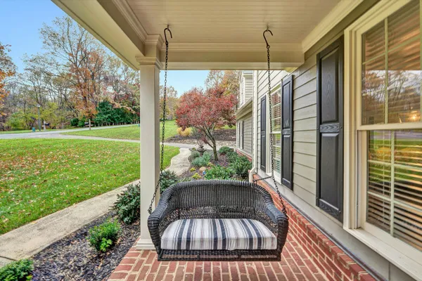 a view of a workspace with furniture and a bookshelf