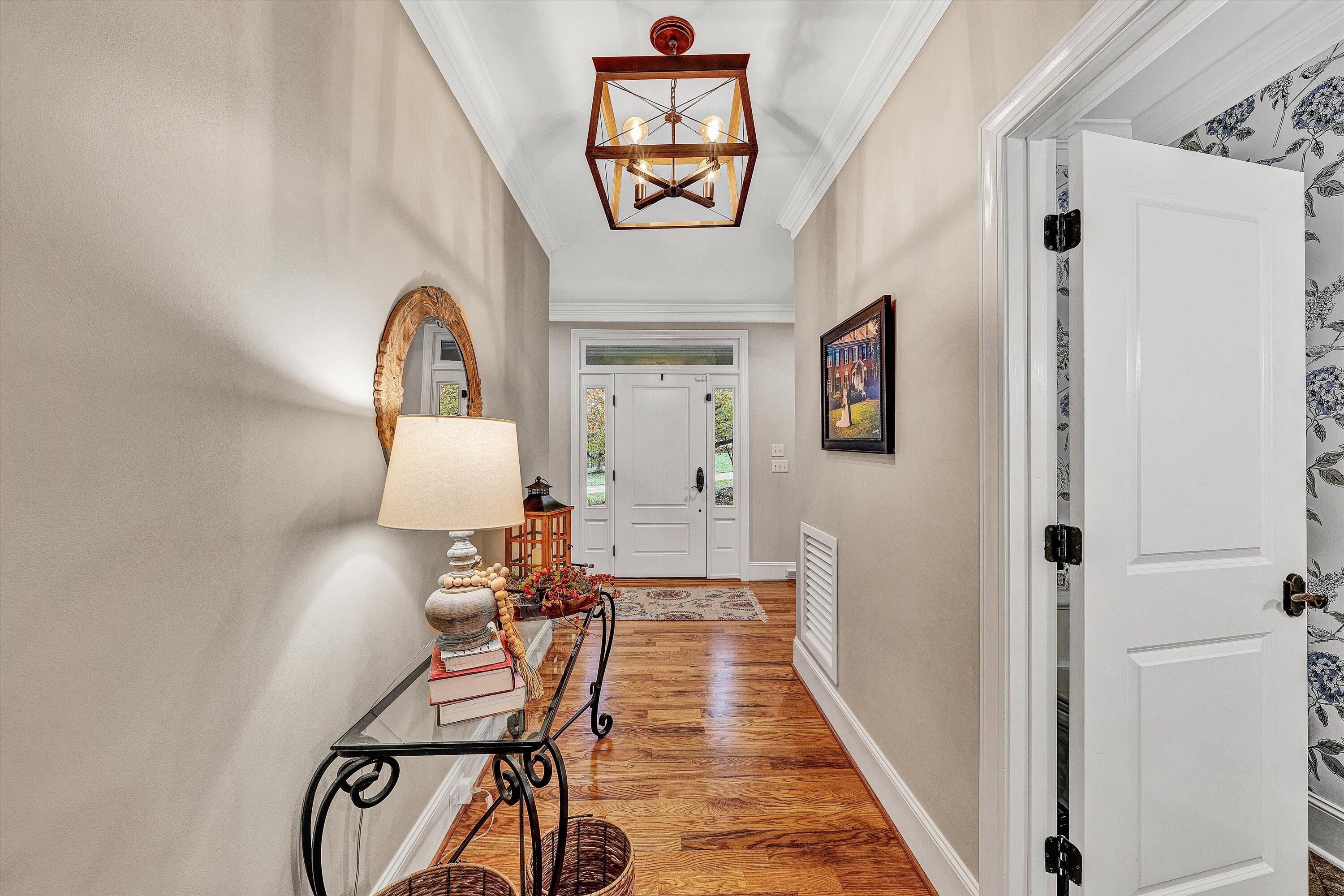 5431 Ridgelea Estates Drive Roanoke, VA 24018 - Photo 7 of 71 a view of a hallway with paintings on the wall